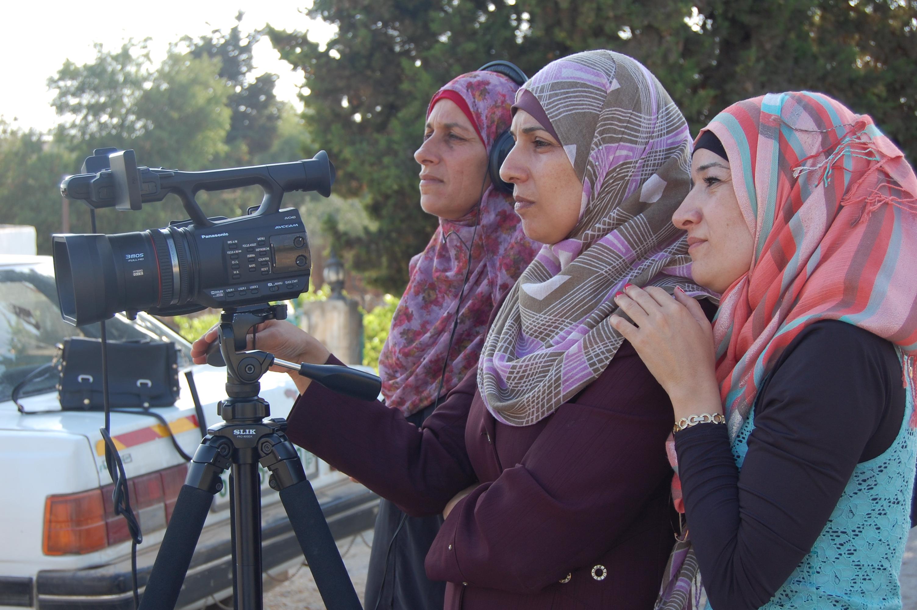Women training with a video camera on a tripod