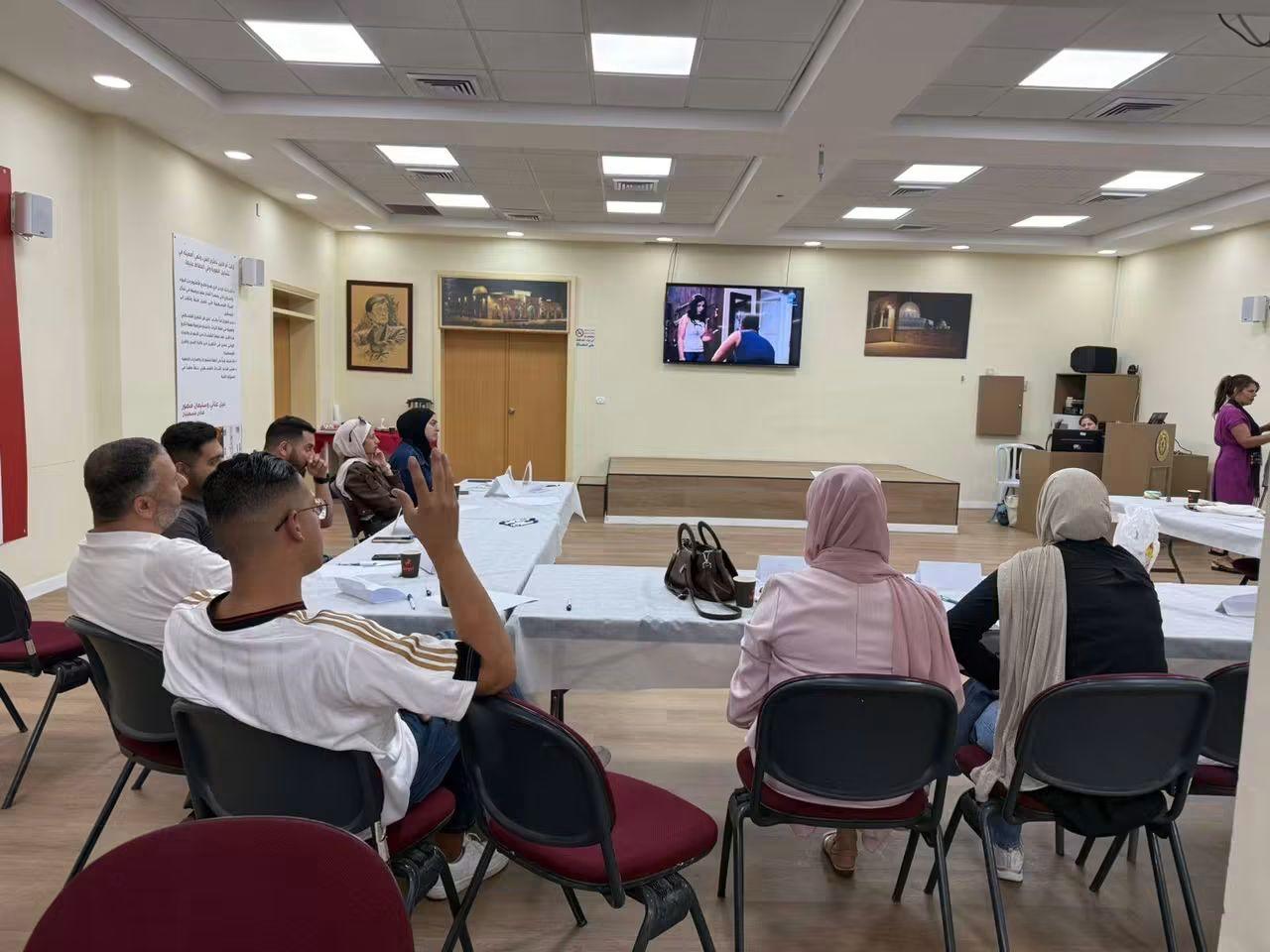A full room of participants at a MEND training session