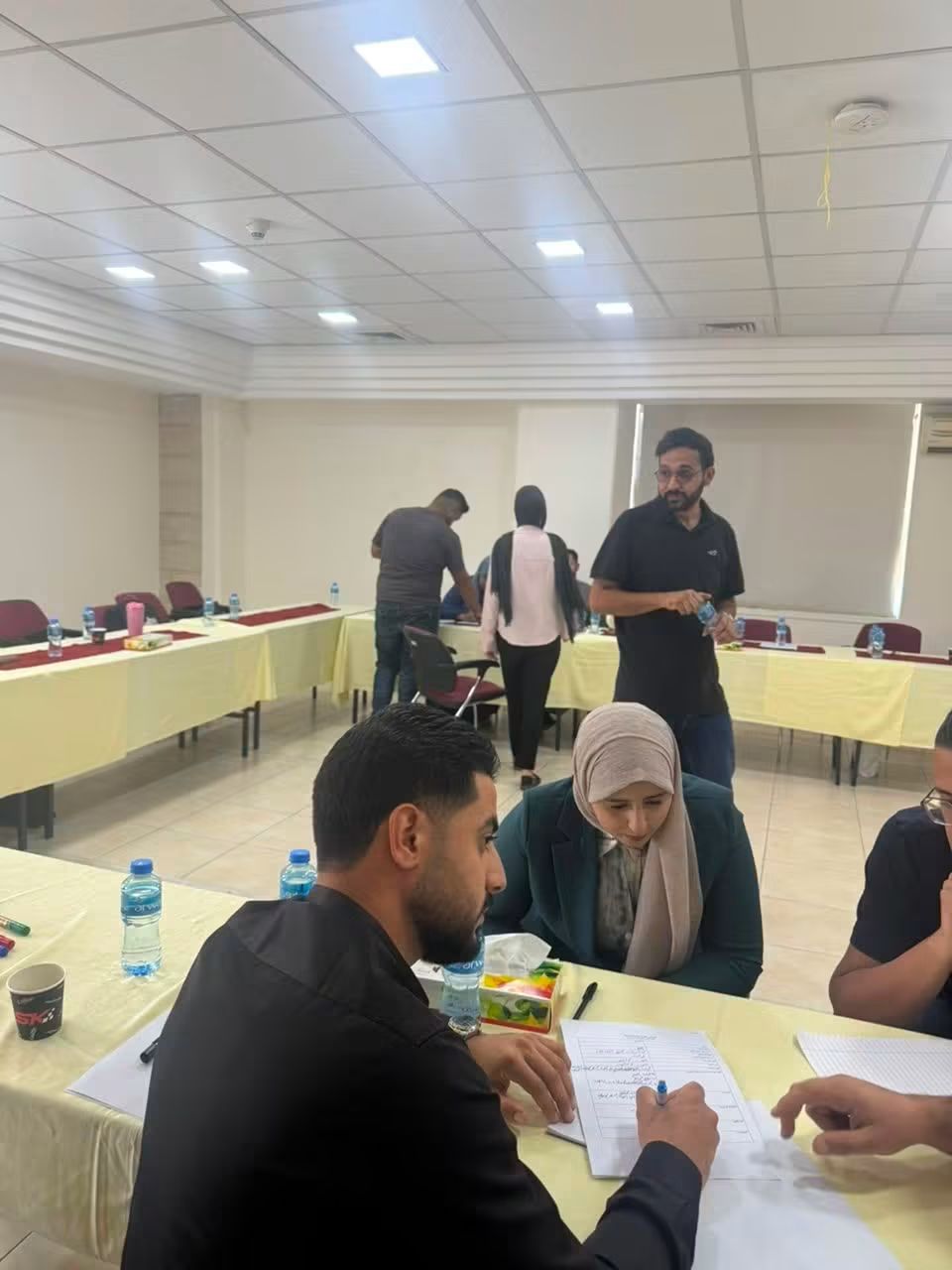 Participants taking notes at a training workshop